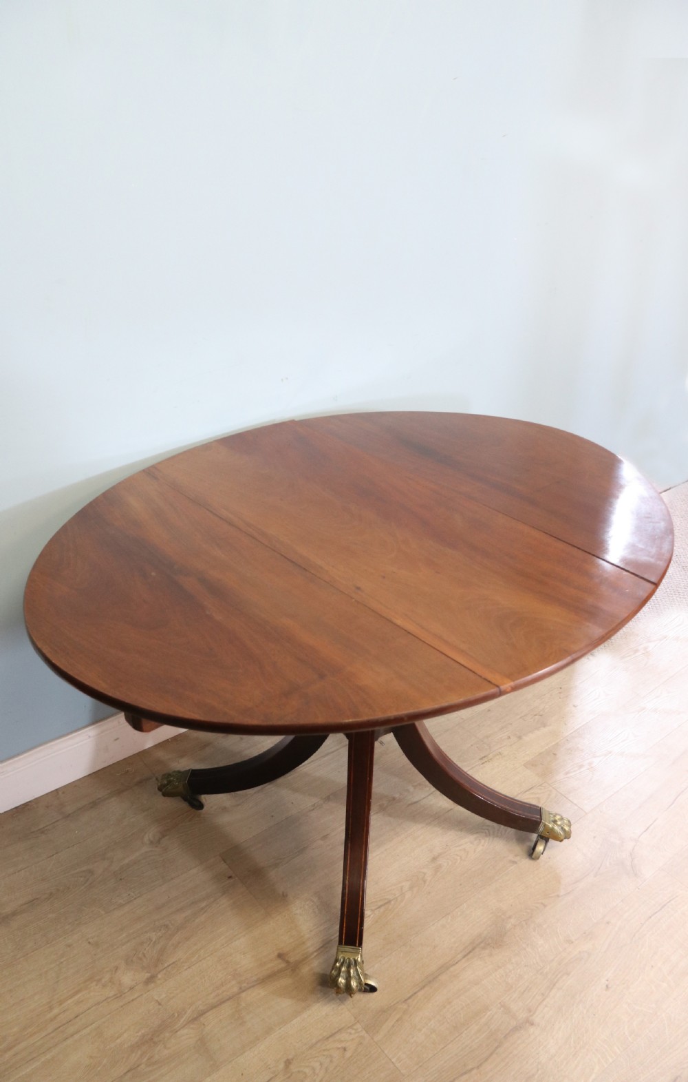 A fine English Antique! A lovely 19th century mahogany oval dining table.  View IV