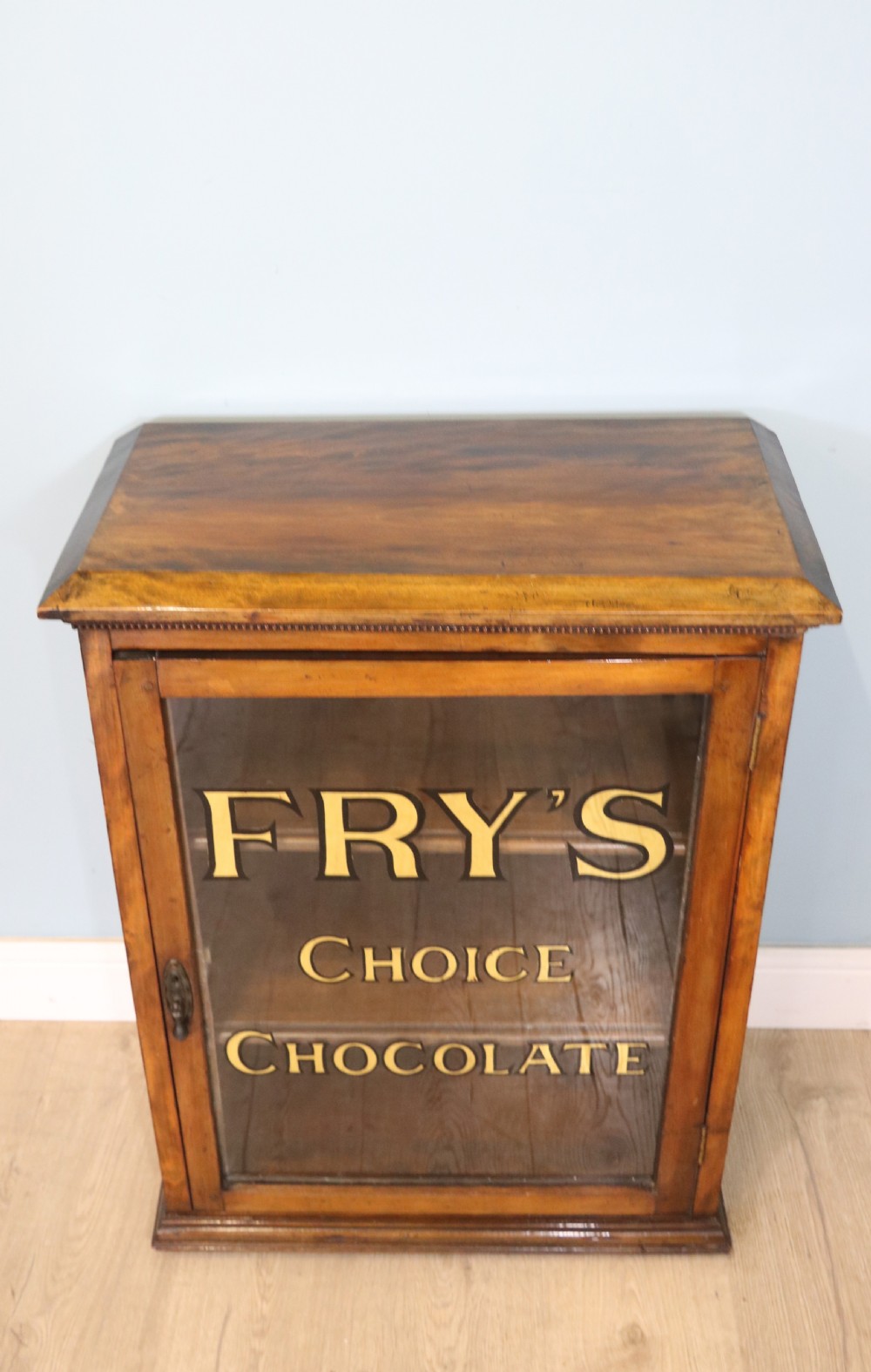 Edwardian hardwood single door display cabinet with 24ct Gold Leaf for Fry’s Choice Chocolate. View V