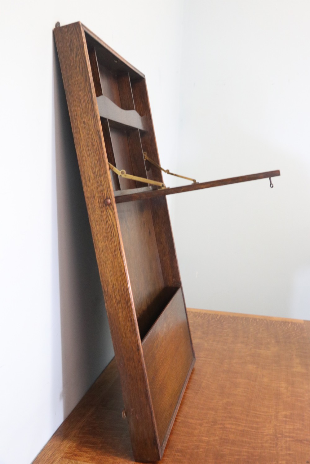 This early 20th century wall mounted oak combination desk and letter rack View VI