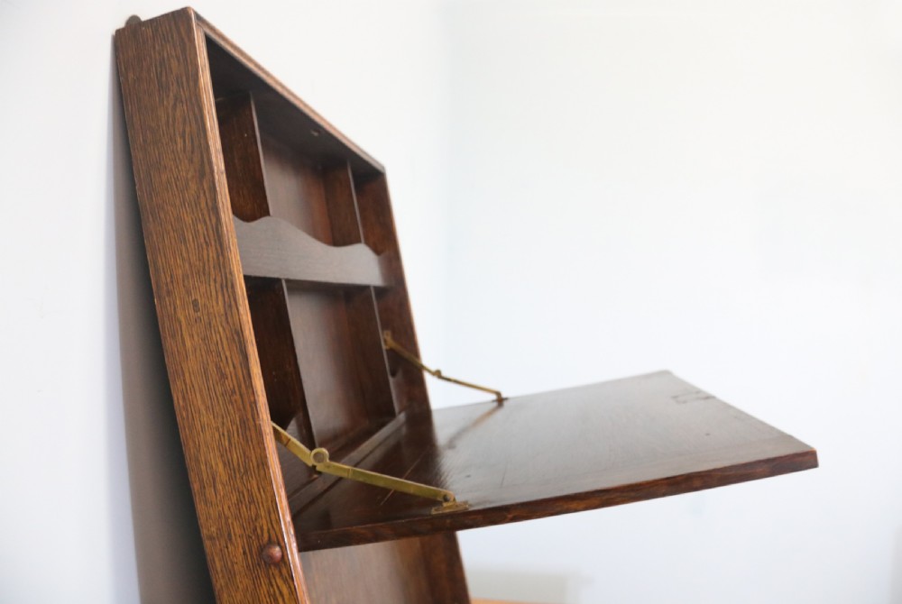 This early 20th century wall mounted oak combination desk and letter rack View VIII