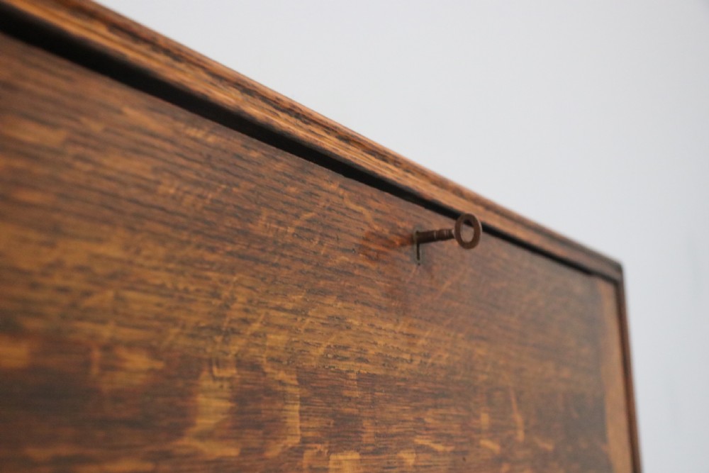This early 20th century wall mounted oak combination desk and letter rack View XI