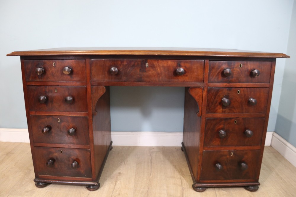 Lovely flame mahogany veneered twin pedestal desk has a tooled leather writing surface  View II