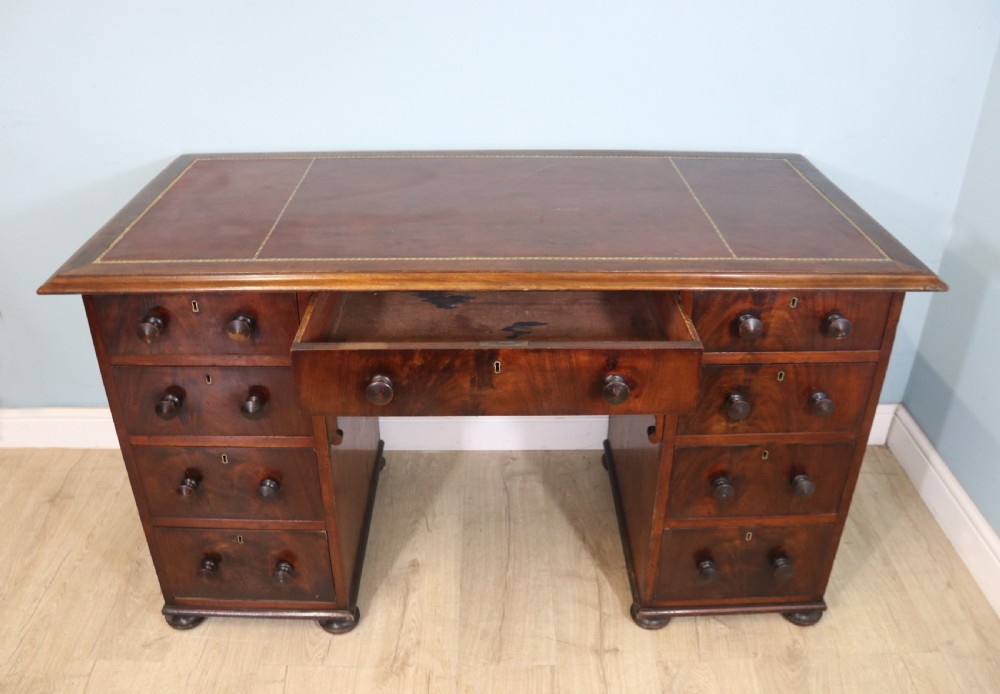 Lovely flame mahogany veneered twin pedestal desk has a tooled leather writing surface  View III