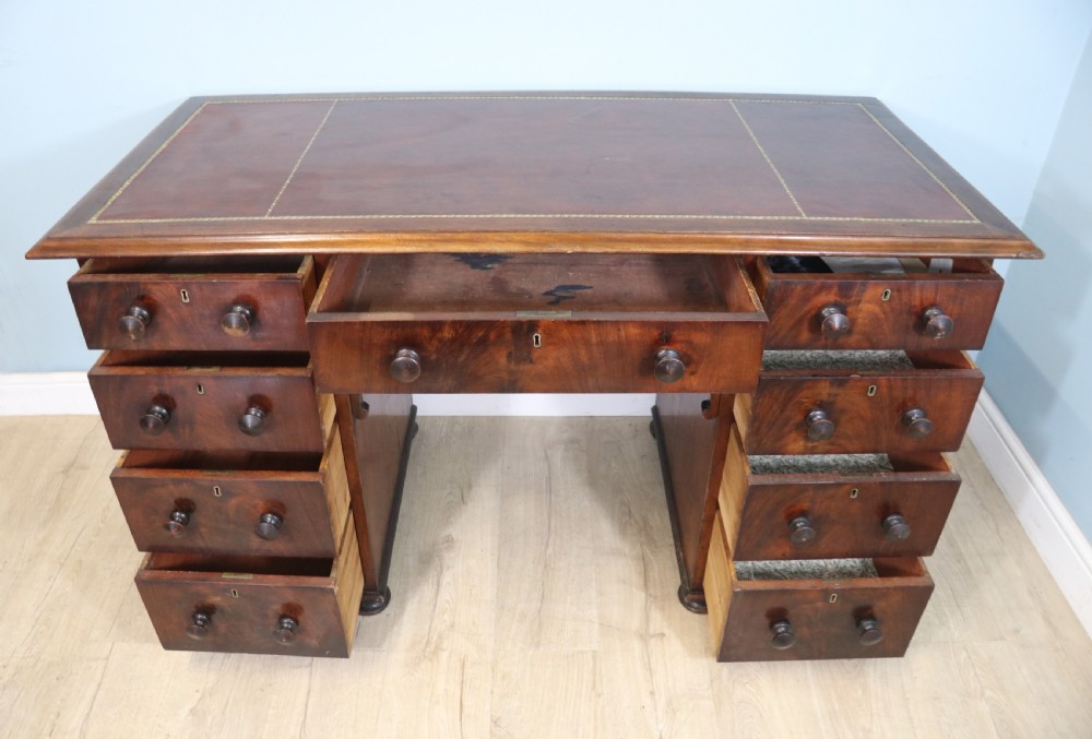 Lovely flame mahogany veneered twin pedestal desk has a tooled leather writing surface  View IV