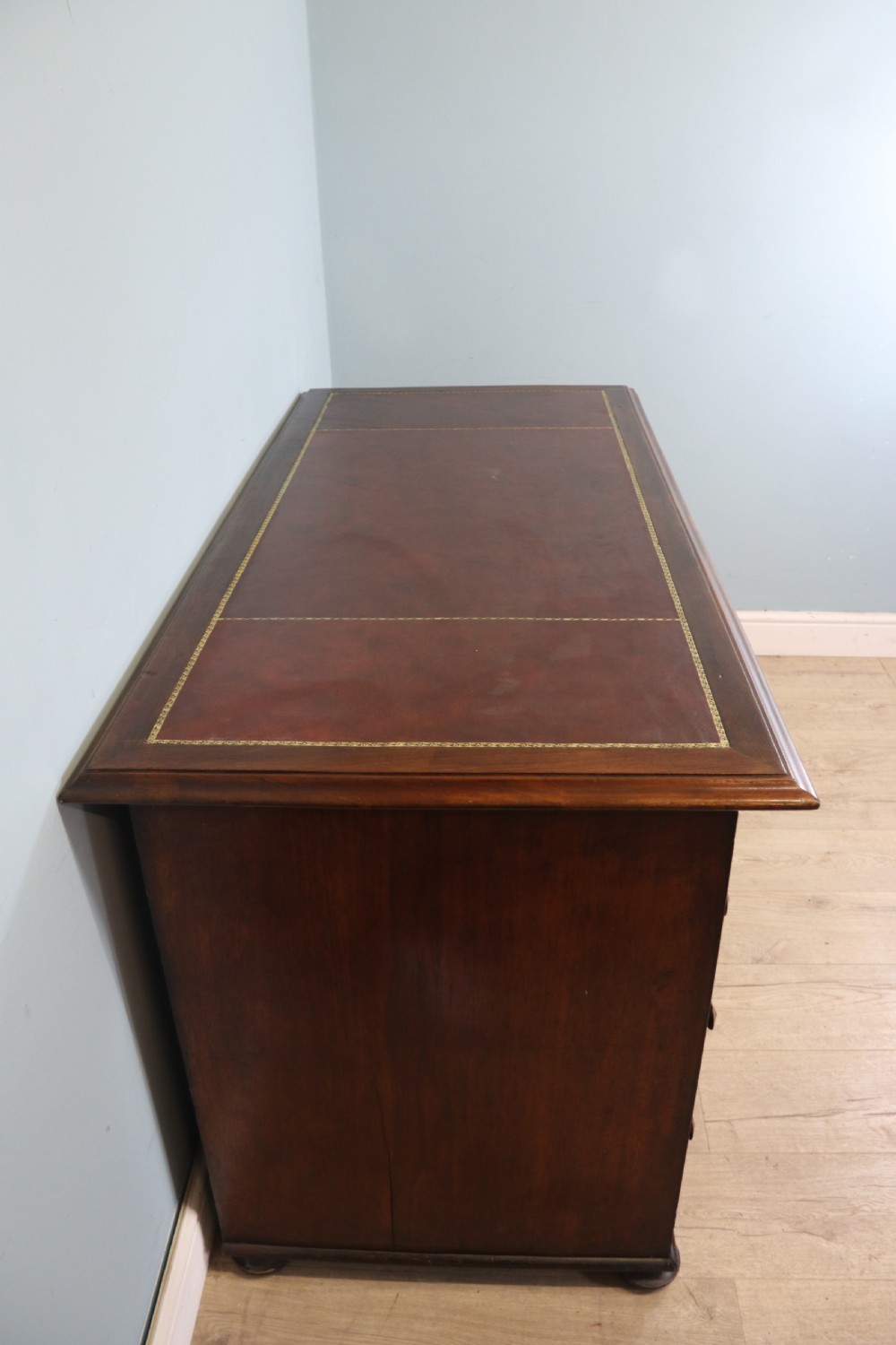 Lovely flame mahogany veneered twin pedestal desk has a tooled leather writing surface  View V