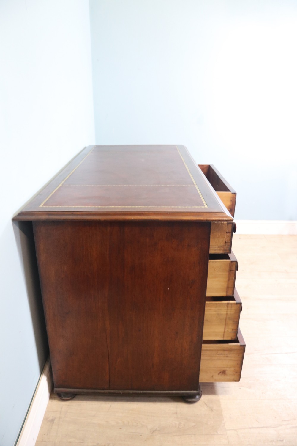 Lovely flame mahogany veneered twin pedestal desk has a tooled leather writing surface  View VI