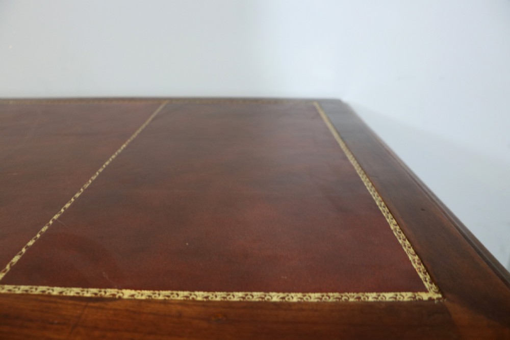 Lovely flame mahogany veneered twin pedestal desk has a tooled leather writing surface  View VII