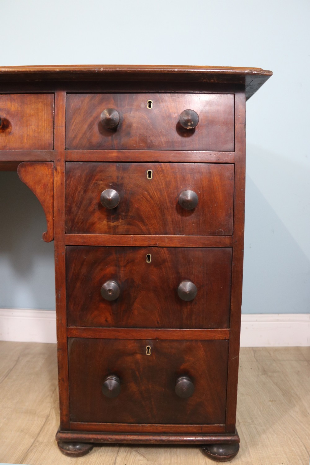 Lovely flame mahogany veneered twin pedestal desk has a tooled leather writing surface  View IX