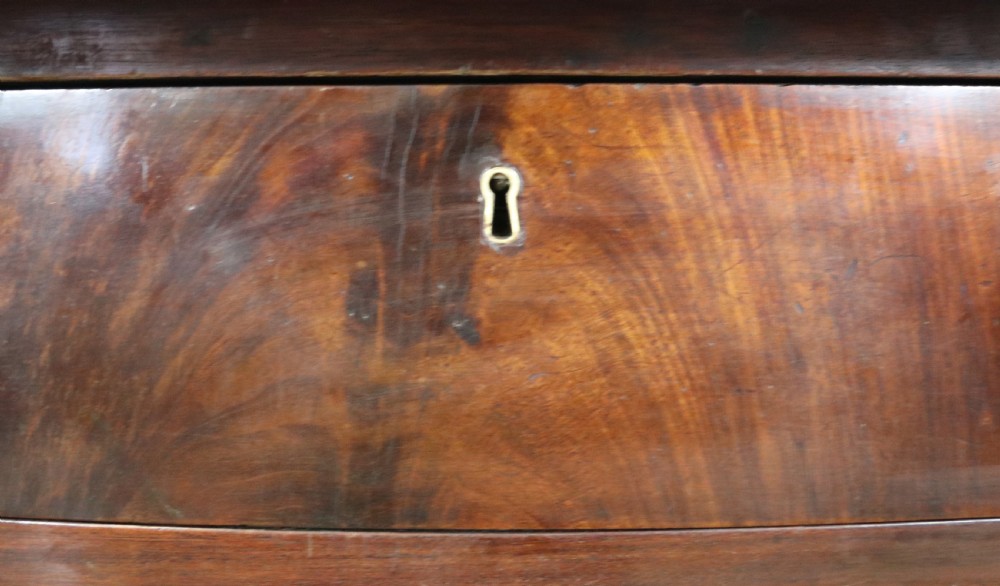 Lovely flame mahogany veneered twin pedestal desk has a tooled leather writing surface  View XII