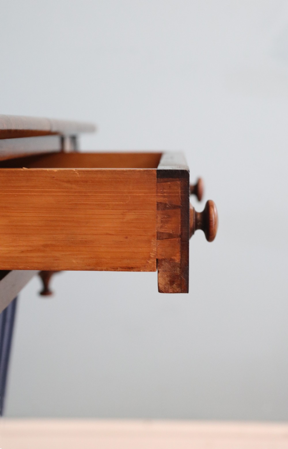 A 19th-century dark rosewood sewing table featuring barley twist legs, side fretwork brackets, a single drawer, and a blue fabric work basket below. View XVIII