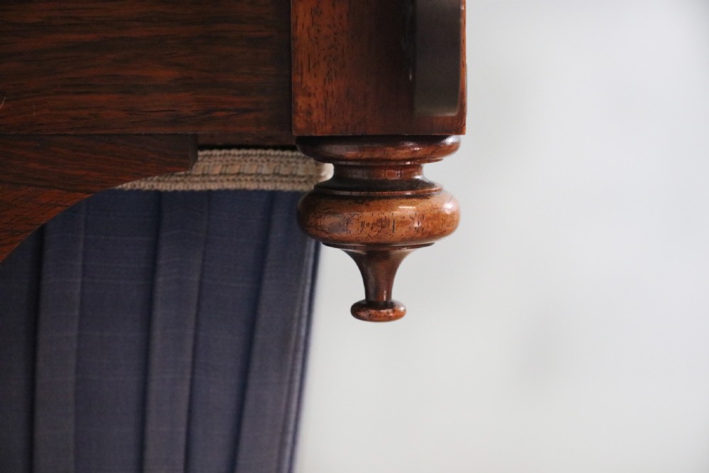 A 19th-century dark rosewood sewing table featuring barley twist legs, side fretwork brackets, a single drawer, and a blue fabric work basket below. View XIX
