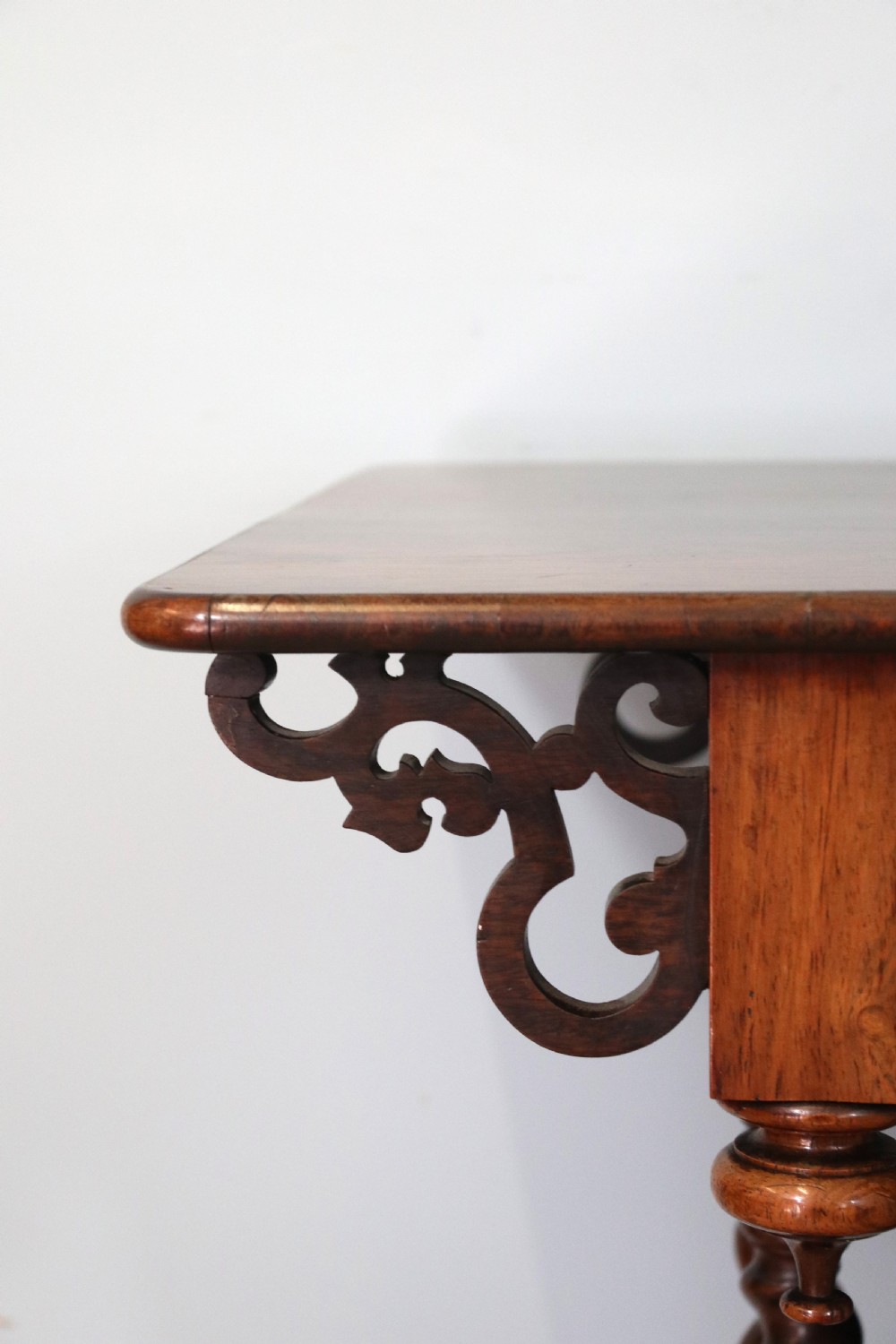 A 19th-century dark rosewood sewing table featuring barley twist legs, side fretwork brackets, a single drawer, and a blue fabric work basket below. View XX
