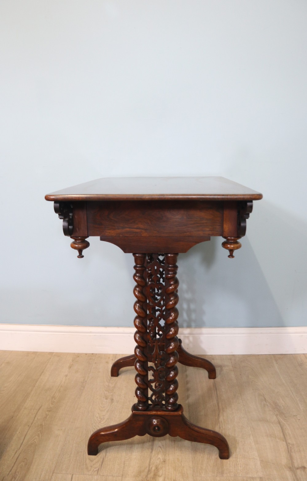A 19th-century dark rosewood sewing table featuring barley twist legs, side fretwork brackets, a single drawer, and a blue fabric work basket below. View XXIII