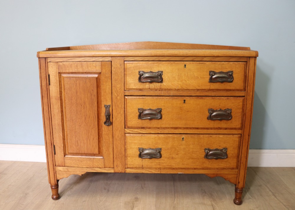 This lovely Arts and Crafts influenced side cabinet