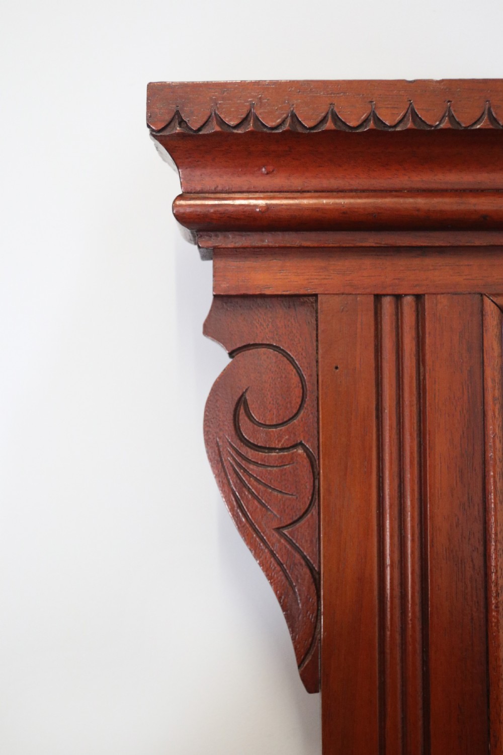 A Victorian American walnut sideboard featuring a mirrored gallery back, carved floral panels, two upper drawers, and two lower cupboard doors. View VIII
