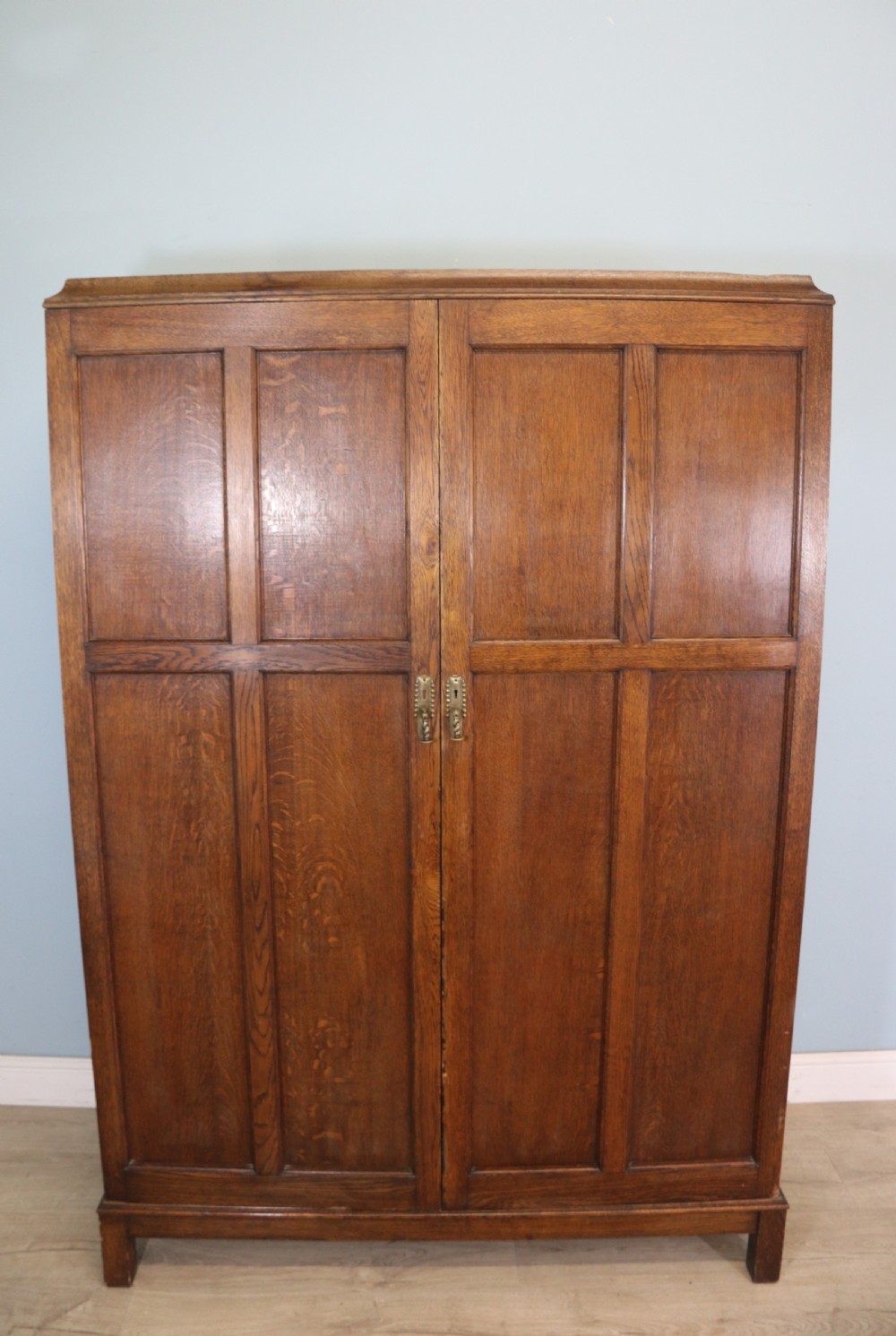A lovely late 19th or early 20th century oak wardrobe in the ‘campaign’ style.