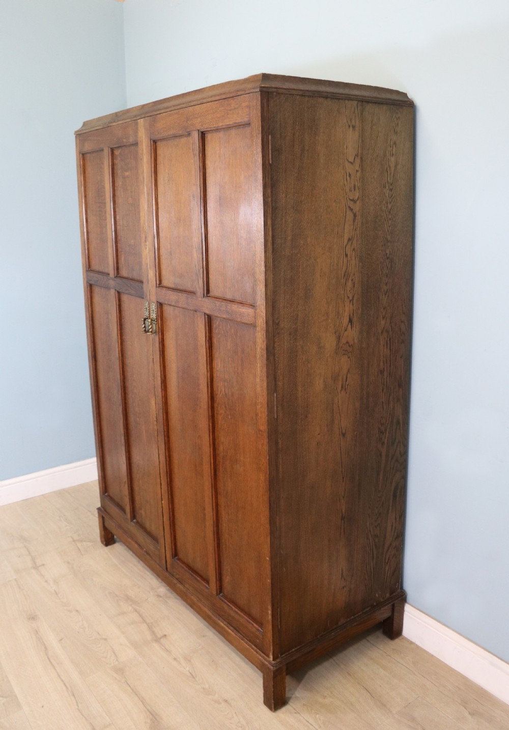 A lovely late 19th or early 20th century oak wardrobe in the ‘campaign’ style. View II