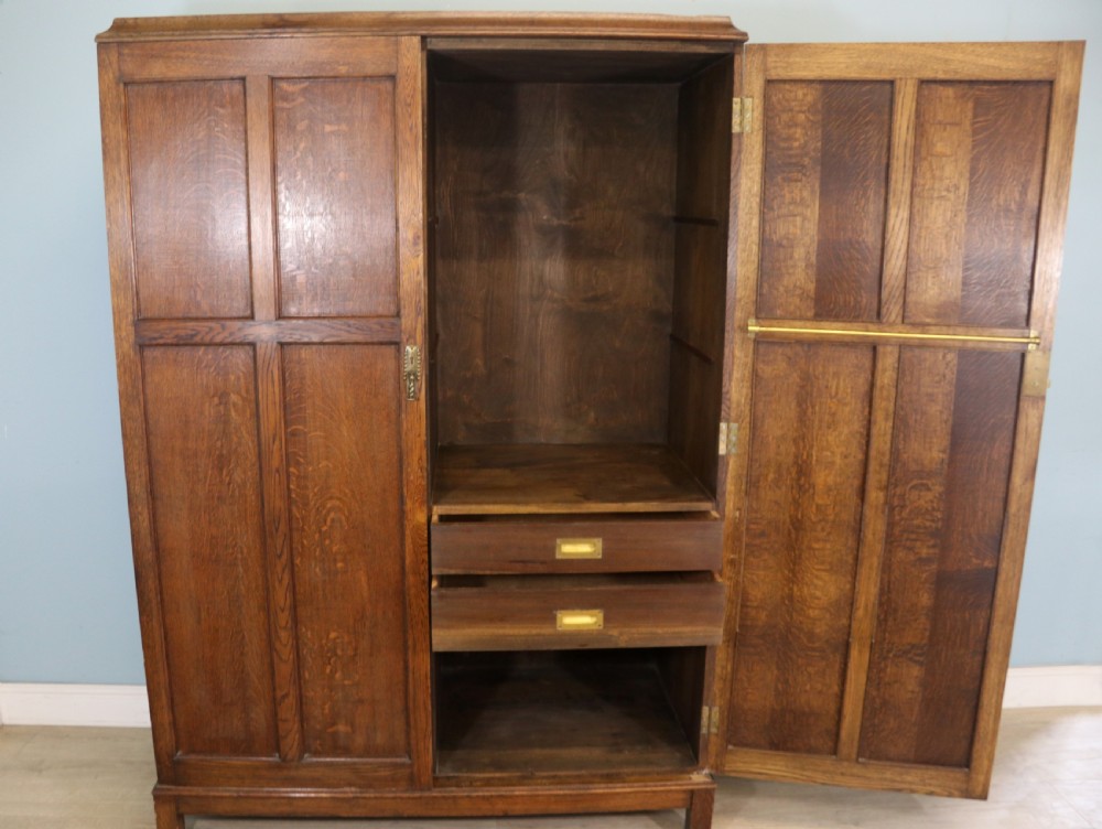 A lovely late 19th or early 20th century oak wardrobe in the ‘campaign’ style. View IV