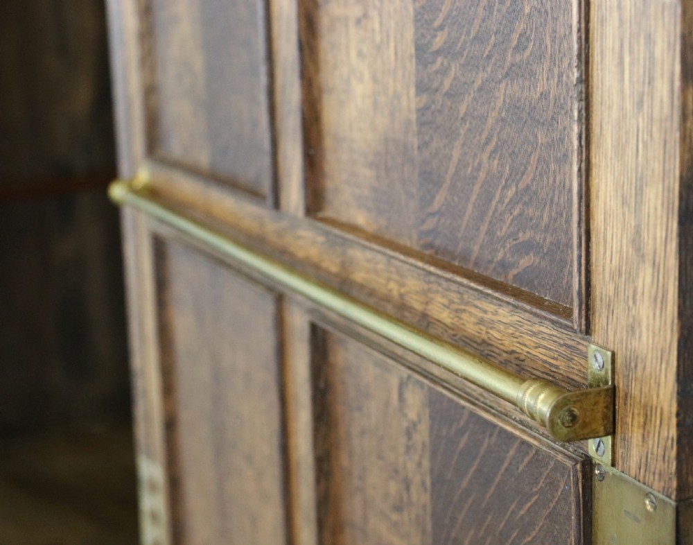 A lovely late 19th or early 20th century oak wardrobe in the ‘campaign’ style. View X