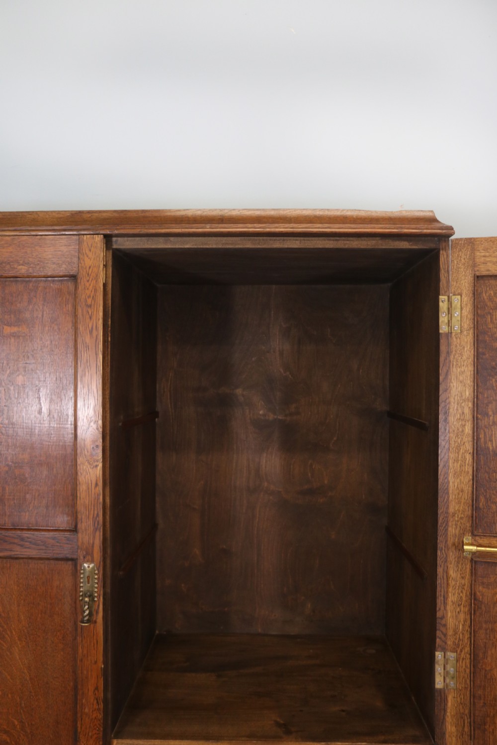 A lovely late 19th or early 20th century oak wardrobe in the ‘campaign’ style. View XI