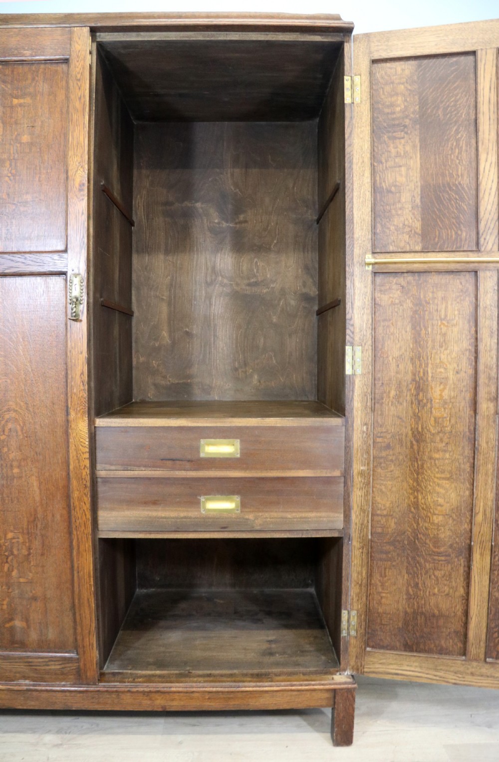 A lovely late 19th or early 20th century oak wardrobe in the ‘campaign’ style. View XII