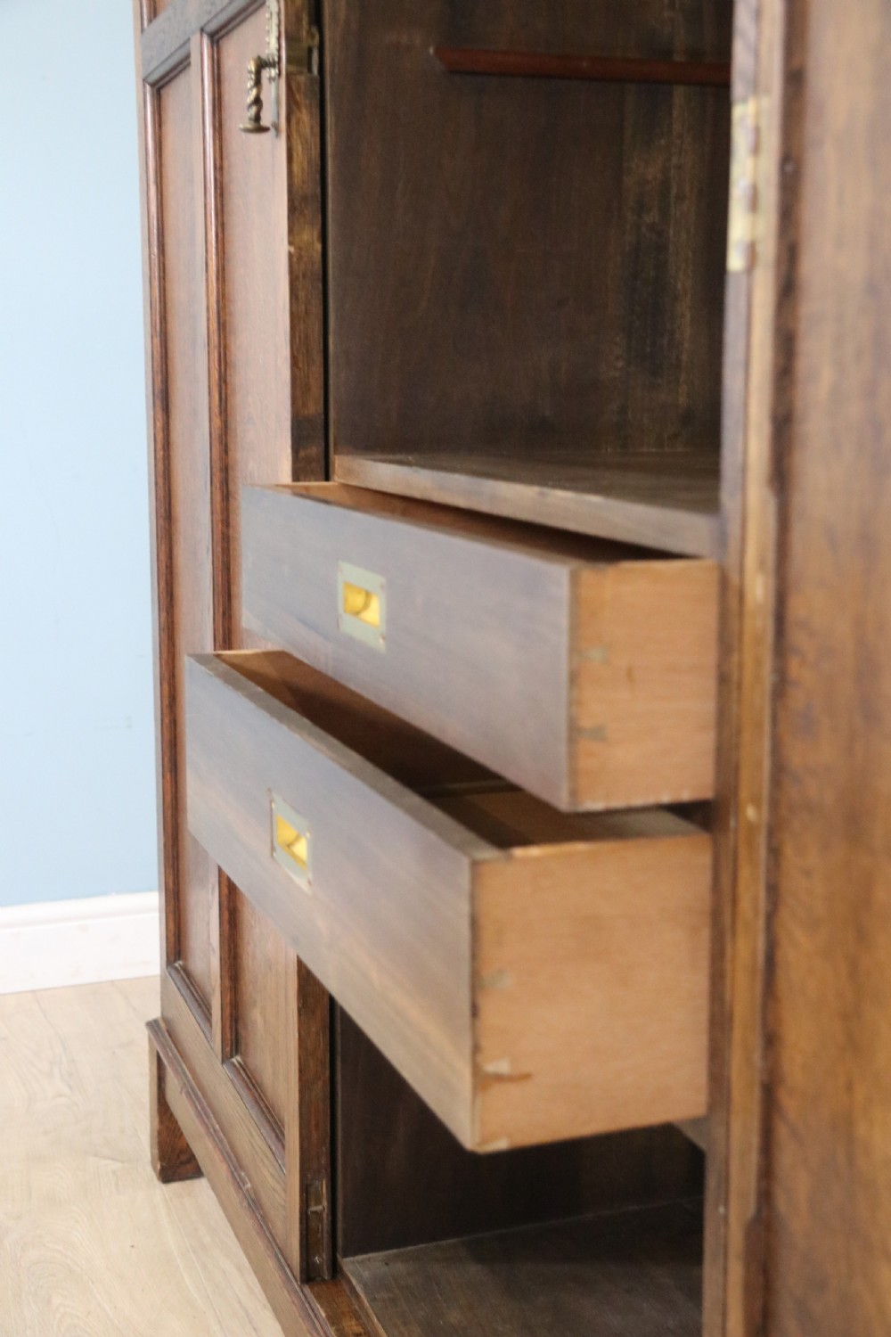 A lovely late 19th or early 20th century oak wardrobe in the ‘campaign’ style. View XIV