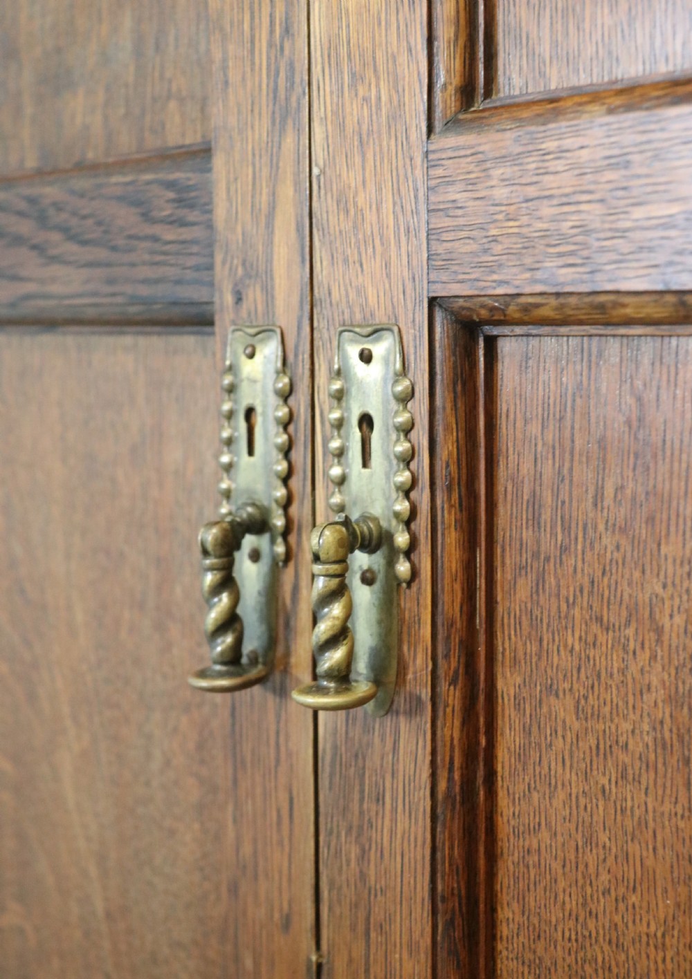 A lovely late 19th or early 20th century oak wardrobe in the ‘campaign’ style. View XX