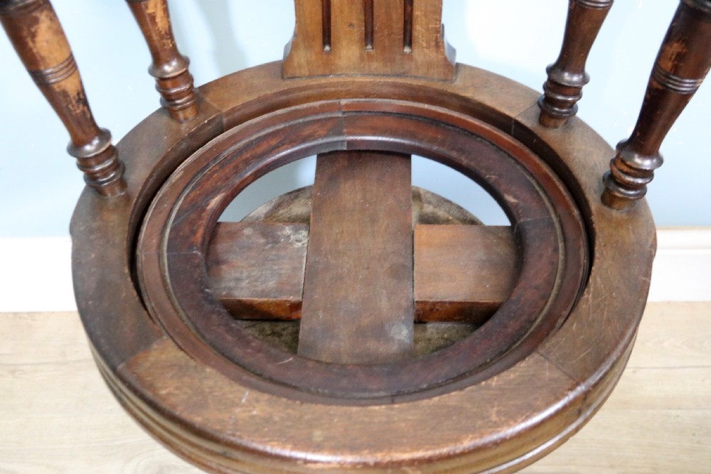 A wonderful late Victorian walnut framed and cast iron based revolving office chair View XVII
