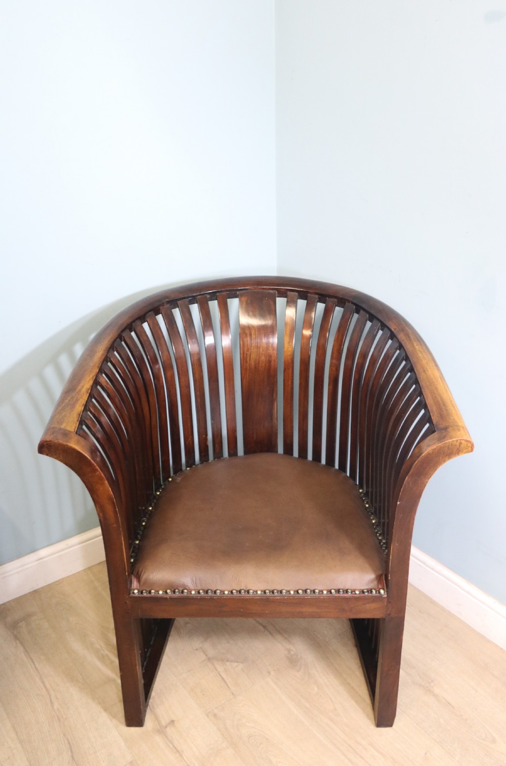 An early 20th century hardwood framed chair with curved back
