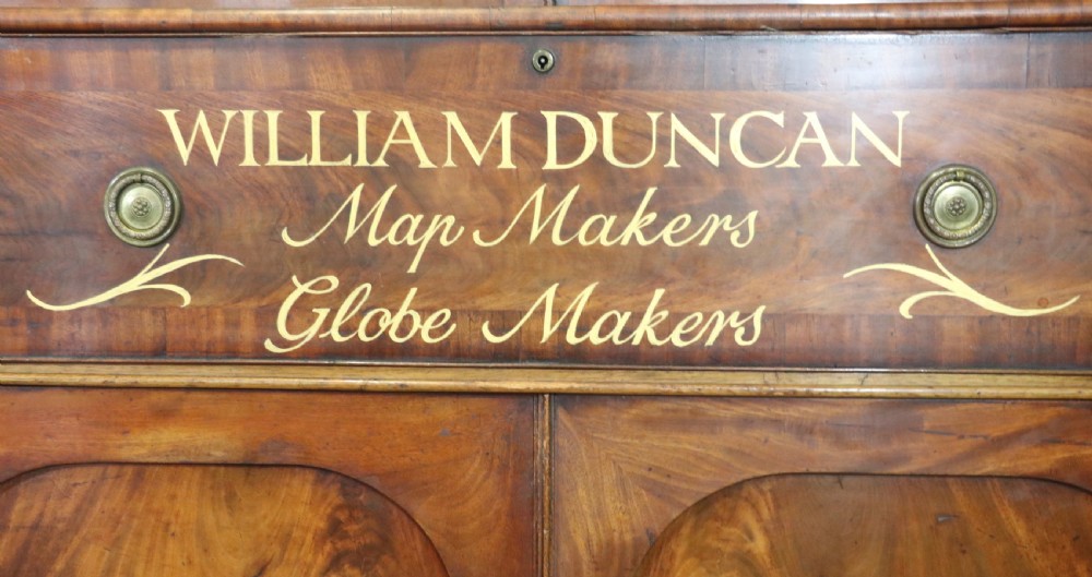 A late Georgian mahogany secretaire bookcase with glazed upper doors featuring Roman numerals, a drop-front fitted writing desk, and two cabinet doors below. View VIII