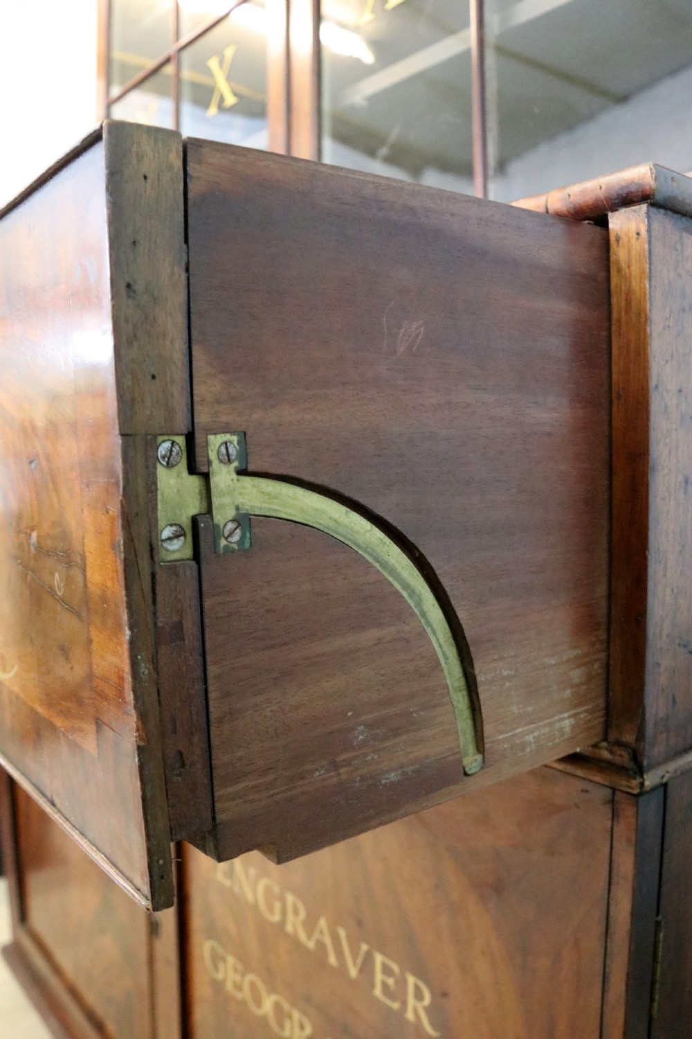 A late Georgian mahogany secretaire bookcase with glazed upper doors featuring Roman numerals, a drop-front fitted writing desk, and two cabinet doors below. View XXV