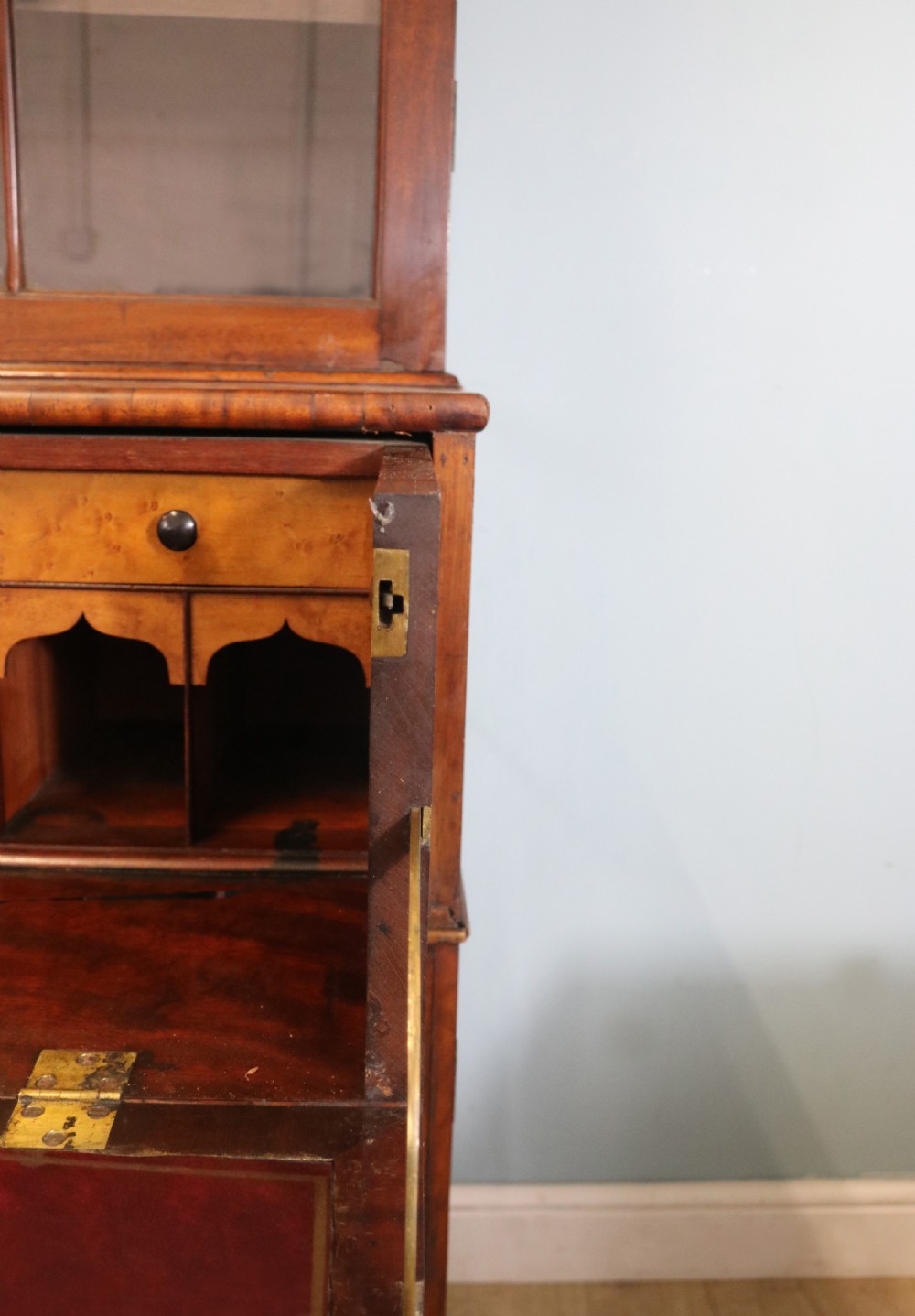 A late Georgian mahogany secretaire bookcase with glazed upper doors featuring Roman numerals, a drop-front fitted writing desk, and two cabinet doors below. View XXVI