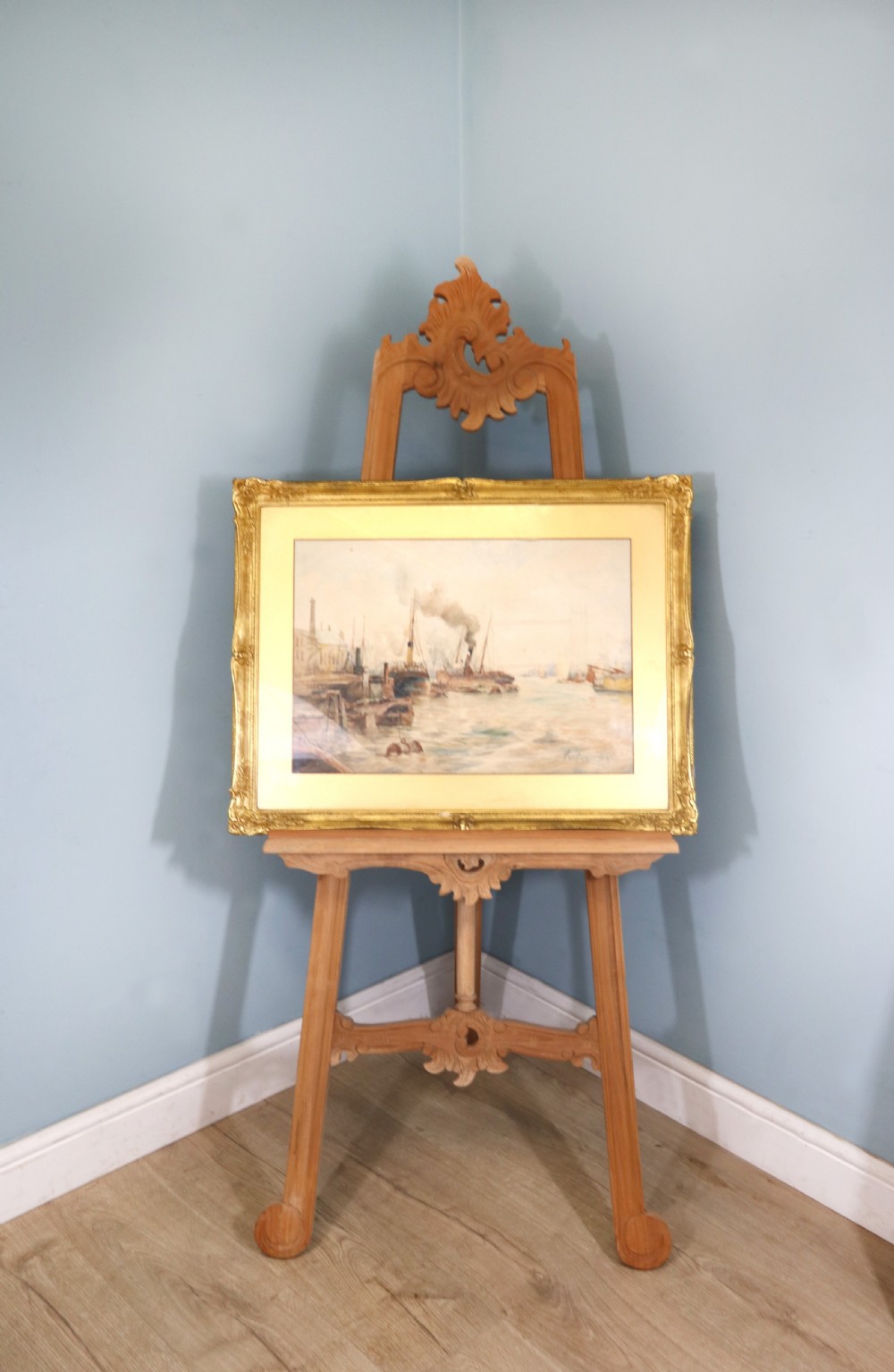 A framed maritime watercolour painting depicting steamships and barges on a river with Tower Bridge in the background, housed in a ornate gilded swept frame. View II