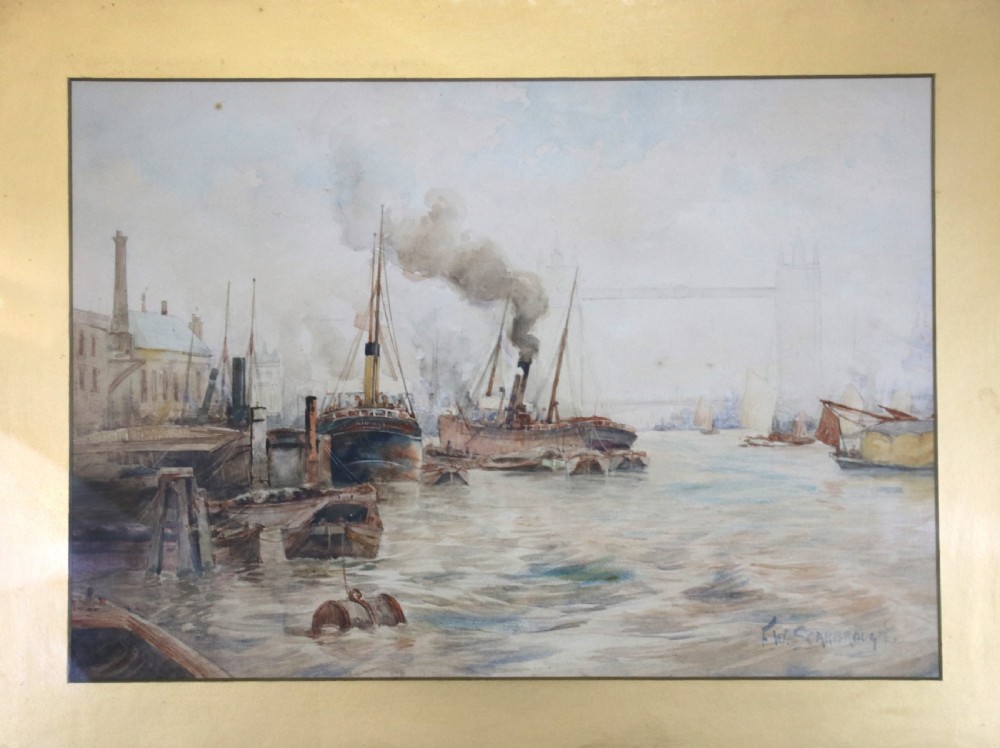 A framed maritime watercolour painting depicting steamships and barges on a river with Tower Bridge in the background, housed in a ornate gilded swept frame. View III
