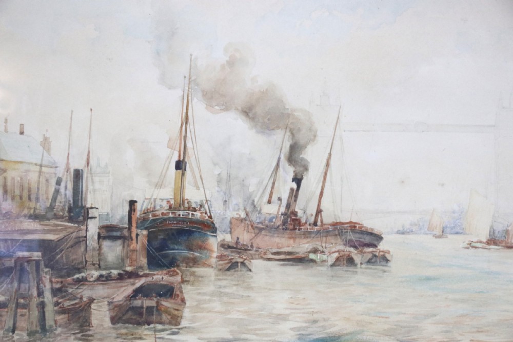 A framed maritime watercolour painting depicting steamships and barges on a river with Tower Bridge in the background, housed in a ornate gilded swept frame. View V