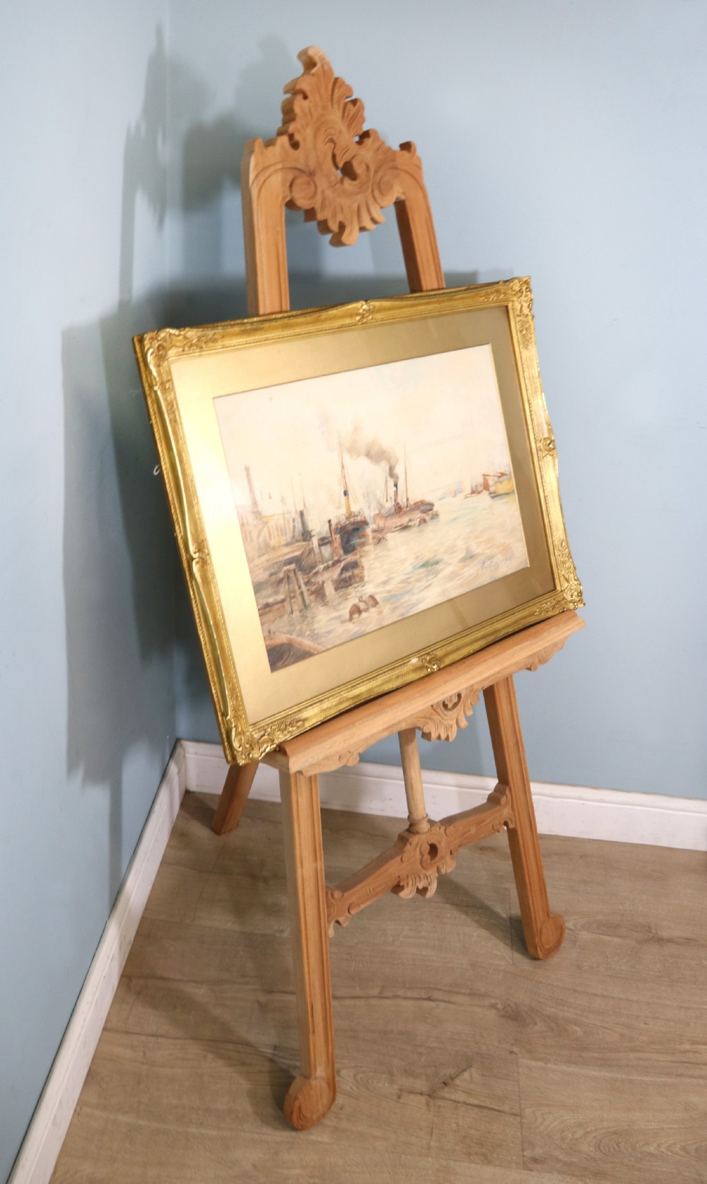 A framed maritime watercolour painting depicting steamships and barges on a river with Tower Bridge in the background, housed in a ornate gilded swept frame. View VI