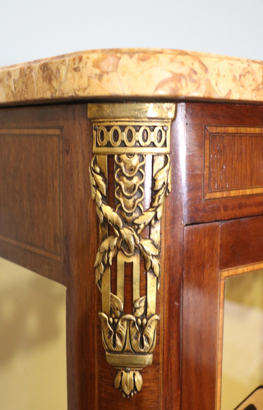 A French mahogany vitrine featuring a marble top, glass display door with gilt perfumery lettering, glass shelves, and brass mounts. View XIV