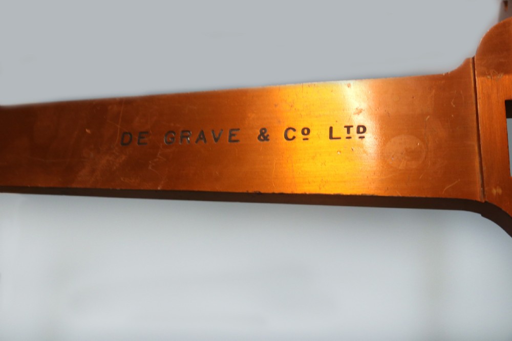 A large hanging brass beam balance scale featuring stamped lettering, suspended chain links, and two circular brass pans. View XIV