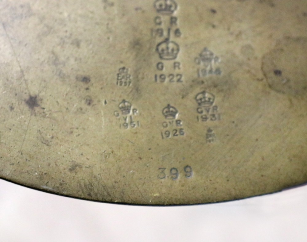 A large hanging brass beam balance scale featuring stamped lettering, suspended chain links, and two circular brass pans. View XXIV