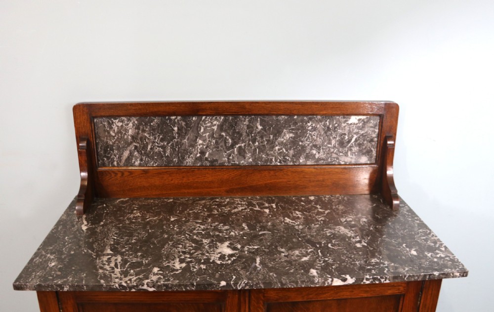 A lovely early 20th Century marble topped oak washstand. View V