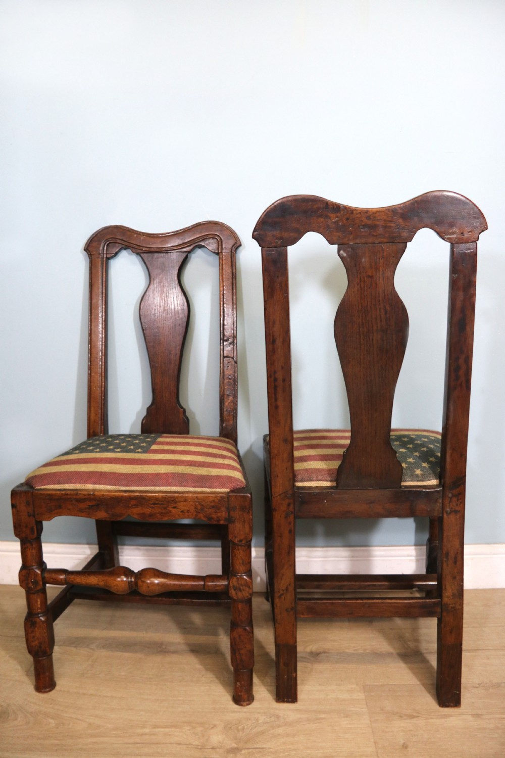 A pair of dark oak side chairs featuring vasiform back splats, turned front stretchers, and seats upholstered in an American flag pattern fabric. View IV
