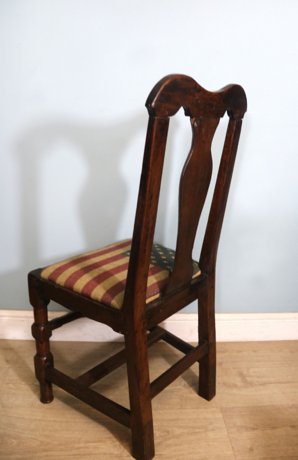 A pair of dark oak side chairs featuring vasiform back splats, turned front stretchers, and seats upholstered in an American flag pattern fabric. View IX