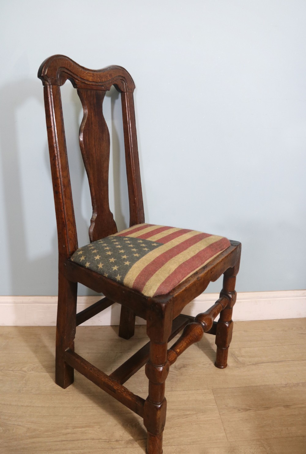 A pair of dark oak side chairs featuring vasiform back splats, turned front stretchers, and seats upholstered in an American flag pattern fabric. View XII