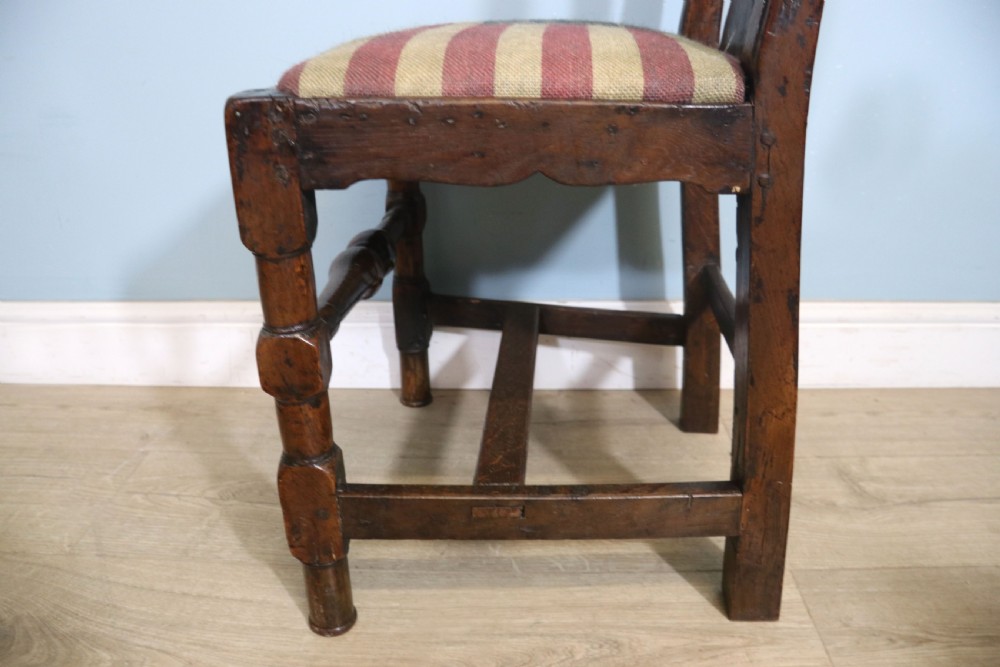 A pair of dark oak side chairs featuring vasiform back splats, turned front stretchers, and seats upholstered in an American flag pattern fabric. View XVII