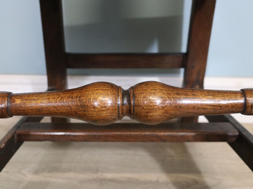 A pair of dark oak side chairs featuring vasiform back splats, turned front stretchers, and seats upholstered in an American flag pattern fabric. View XVIII