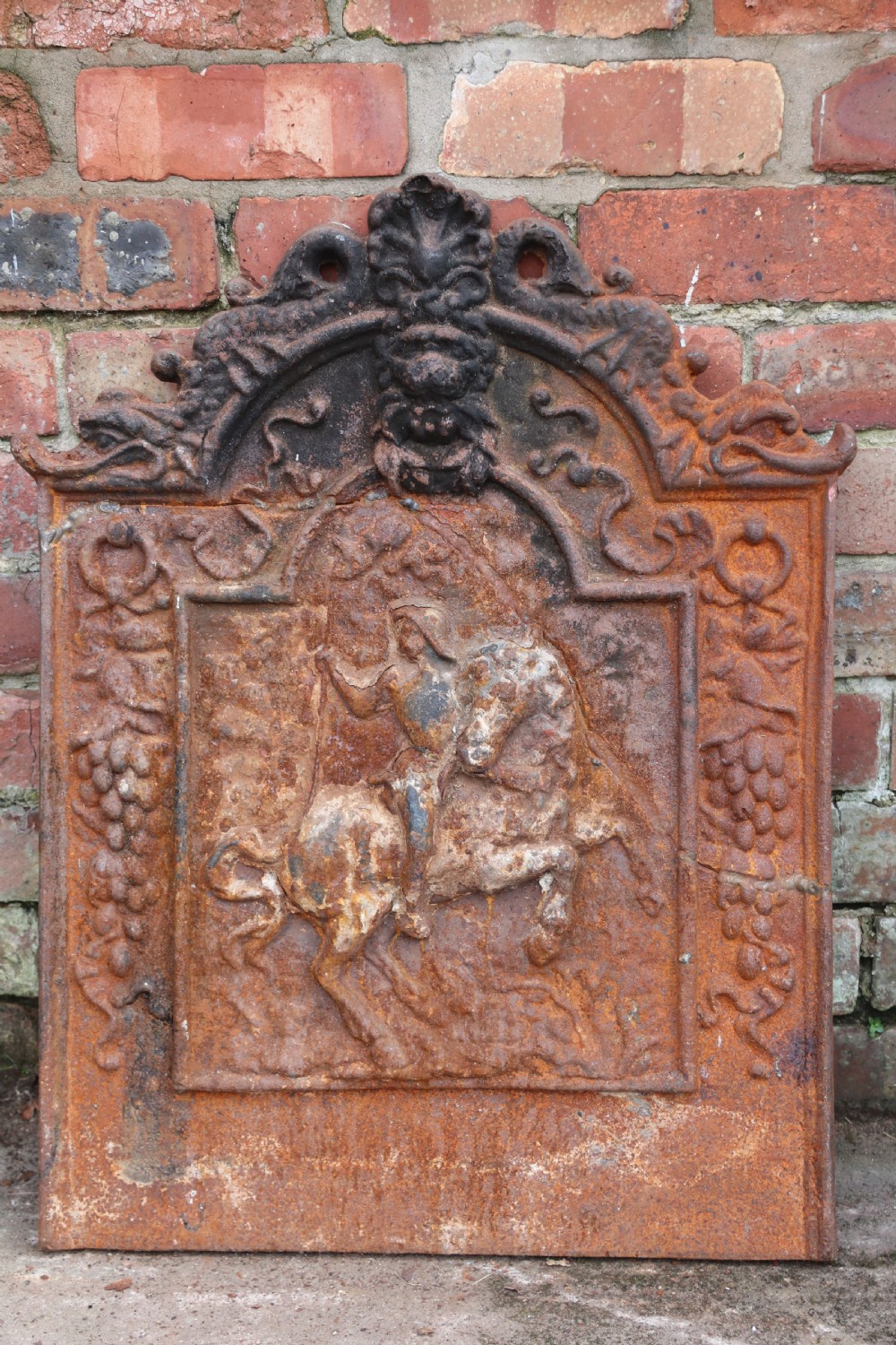 A quality cast iron arch top fireback