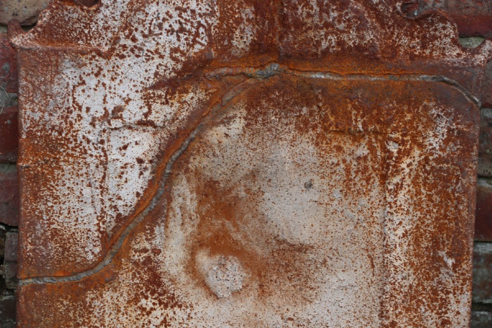 A quality cast iron arch top fireback View XI