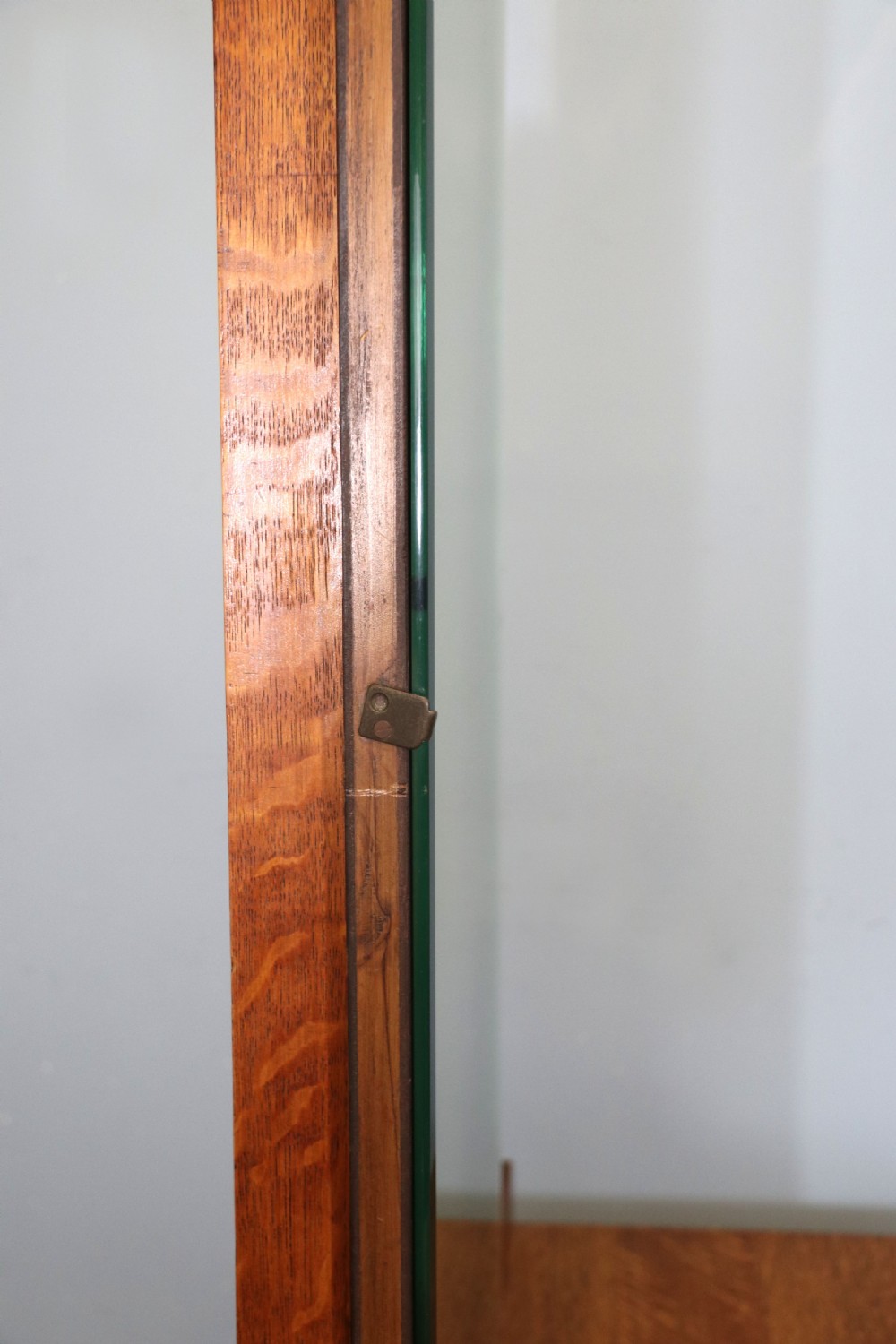 An asymmetrical golden oak dressing chest with a left-hand side cupboard, two drawers on the right, metal handles, and an off-centre tall mirror. View XI