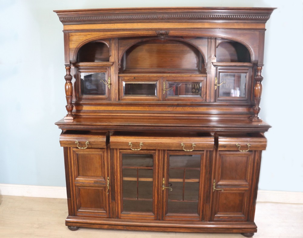 A large Victorian rosewood sideboard featuring an upper tier with arched alcoves, mirrors, and glazed cabinets over a lower base with drawers and panelled doors. View III