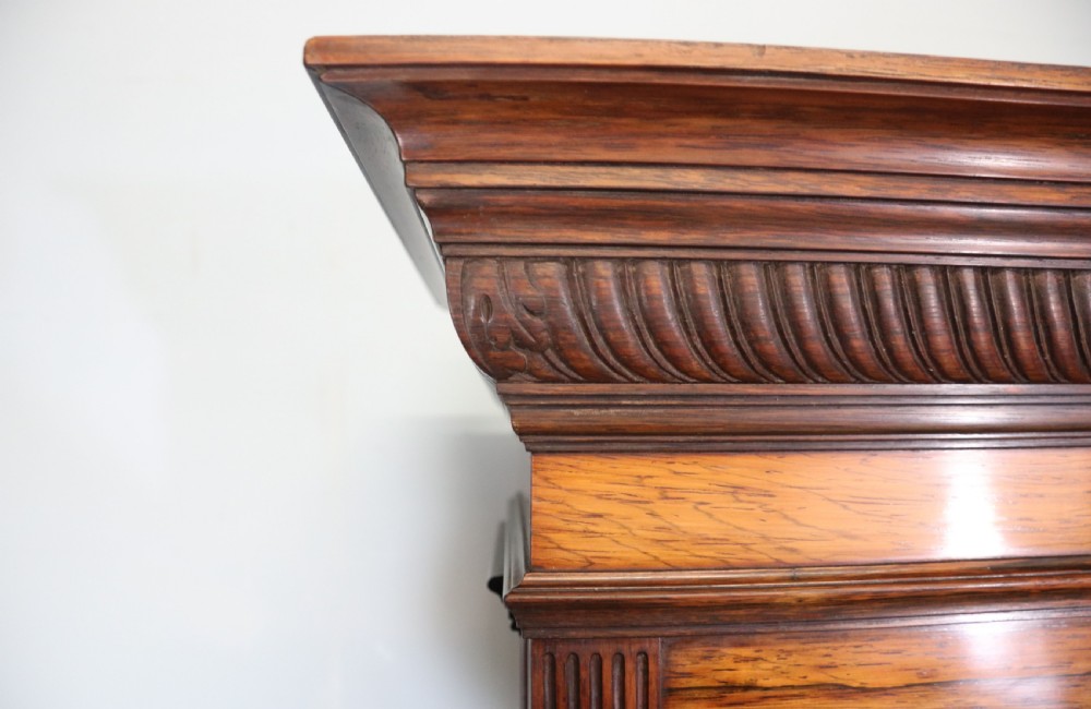 A large Victorian rosewood sideboard featuring an upper tier with arched alcoves, mirrors, and glazed cabinets over a lower base with drawers and panelled doors. View VII